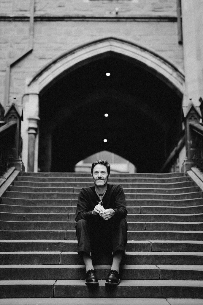 Rolan John Sitting on Stairs